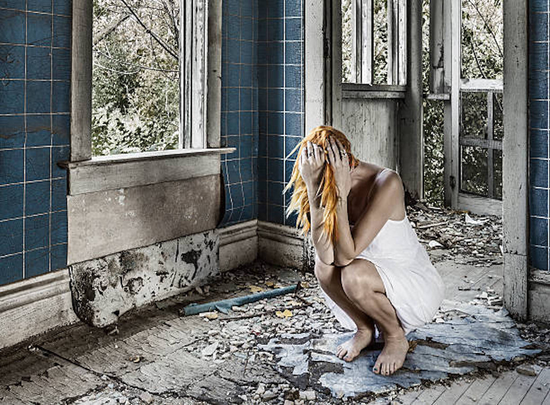 Sad Woman Crouching, Sobbing Amid Ruins